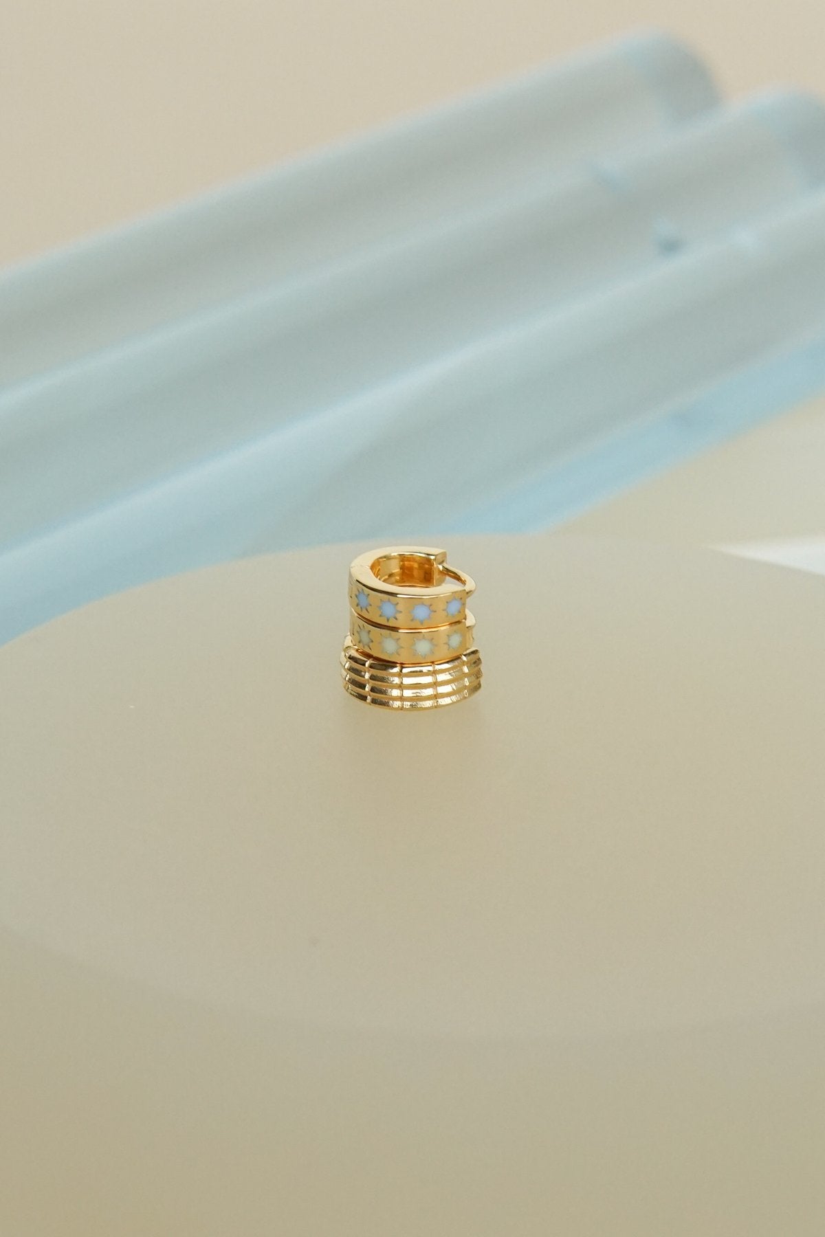 Blue sky star huggie gold plated-abc